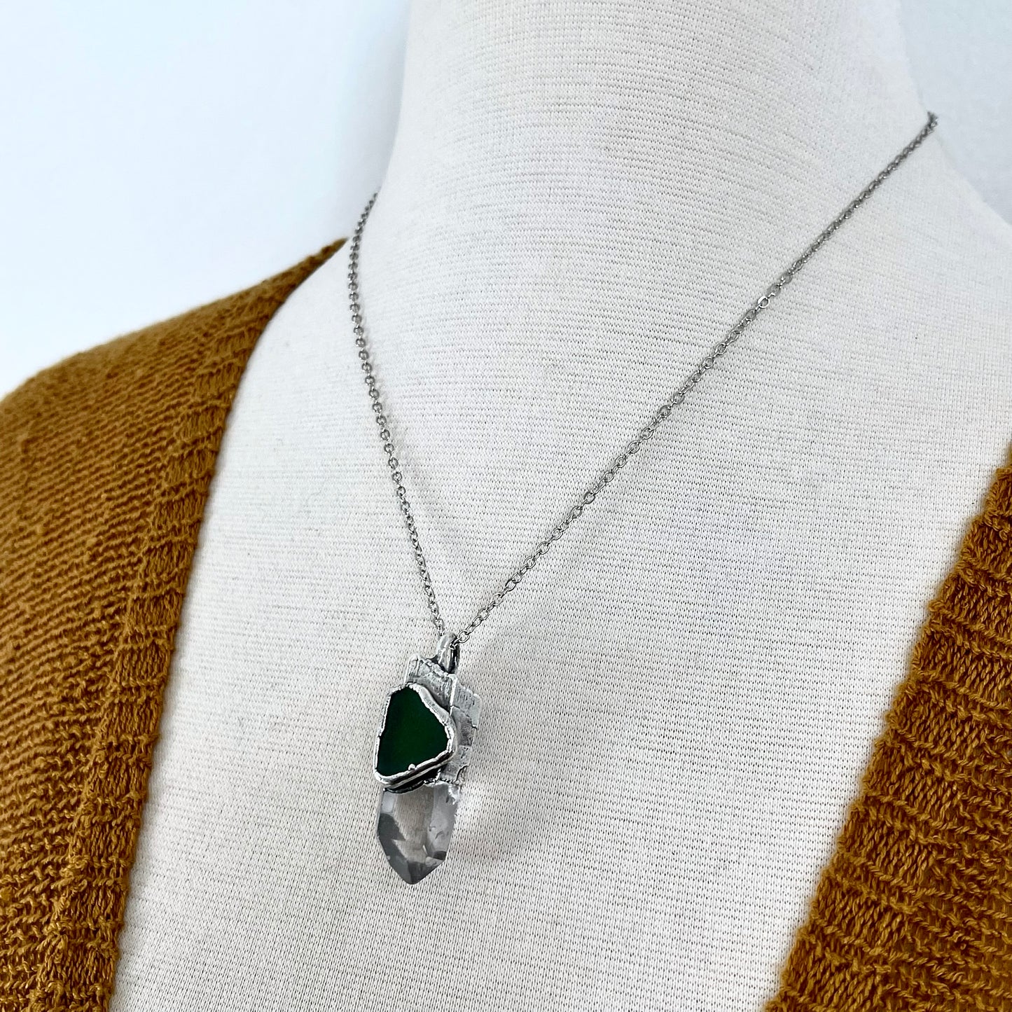 Close-up of FOXLARK Clear Quartz and green sea glass crystal statement necklace in fine silver, showcasing its unique design and craftsmanship.