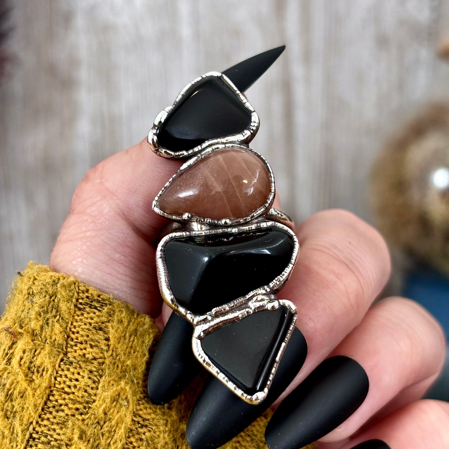 Silver ring featuring multi-colored black obsidian and sun stone with intricate detailing, size 10, from FOXLARK collection.