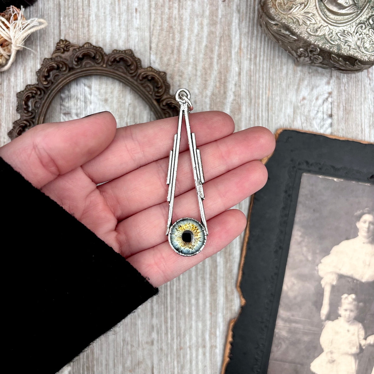 Silver eyeball necklace from FOXLARK collection featuring a detailed blue eyeball pendant on a fine chain.