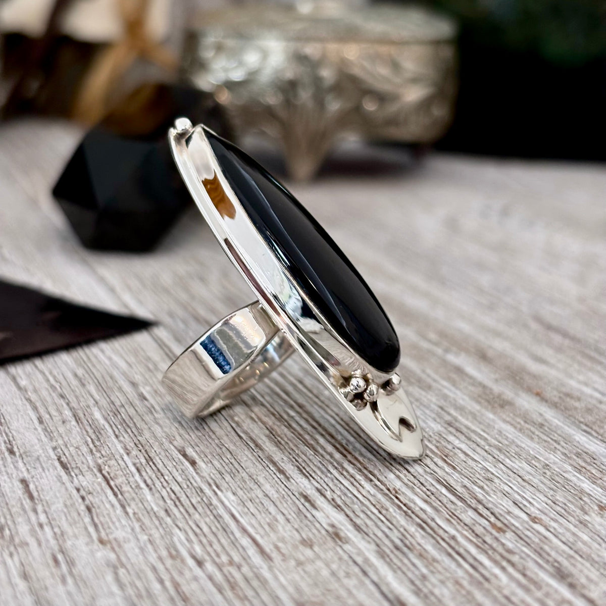 Black Onyx ring by FOXLARK featuring sterling silver band with a large black gemstone, adjustable size, gothic and witchy jewelry style.