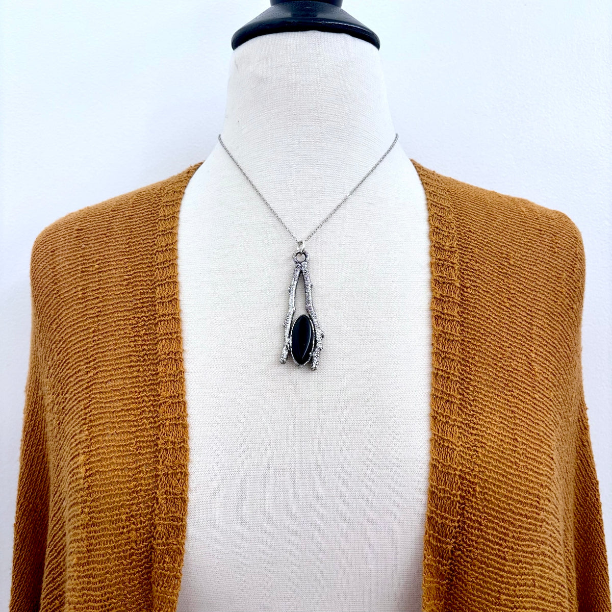 Black onyx crystal necklace from FOXLARK's Sticks & Stones collection featuring a sleek silver chain and elegant design.