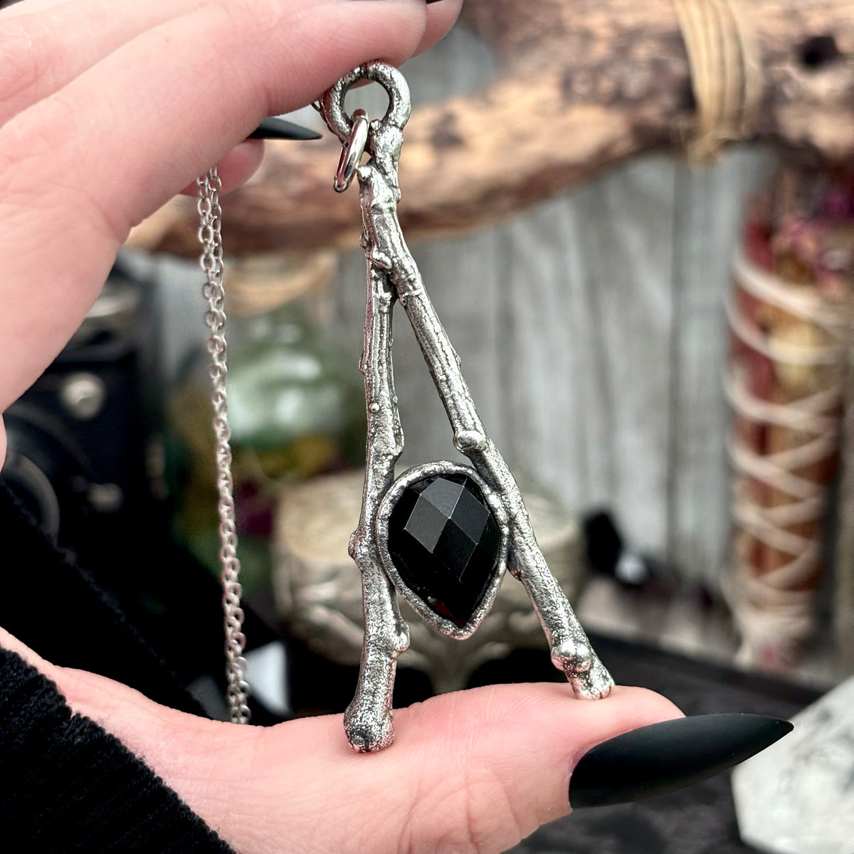 Black onyx crystal necklace with silver chain from FOXLARK's Sticks & Stones collection, featuring a polished black onyx pendant.
