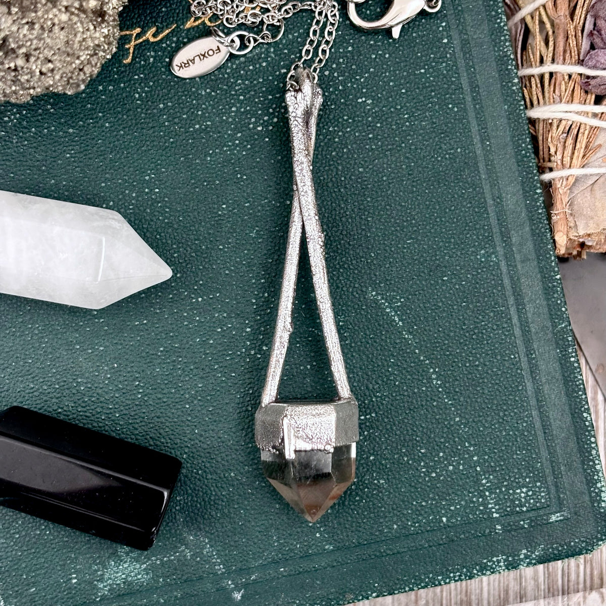 Silver quartz crystal necklace from FOXLARK's Sticks & Stones collection featuring a polished quartz pendant on a silver chain.