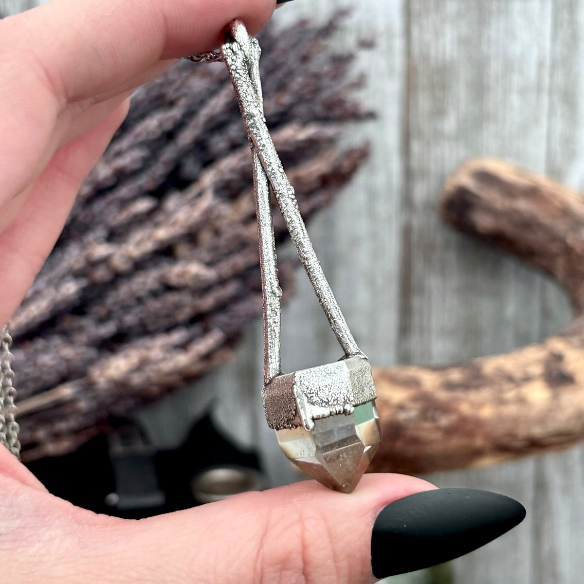 Silver quartz crystal necklace from FOXLARK in the Sticks & Stones Collection, featuring a polished quartz pendant on a silver chain.