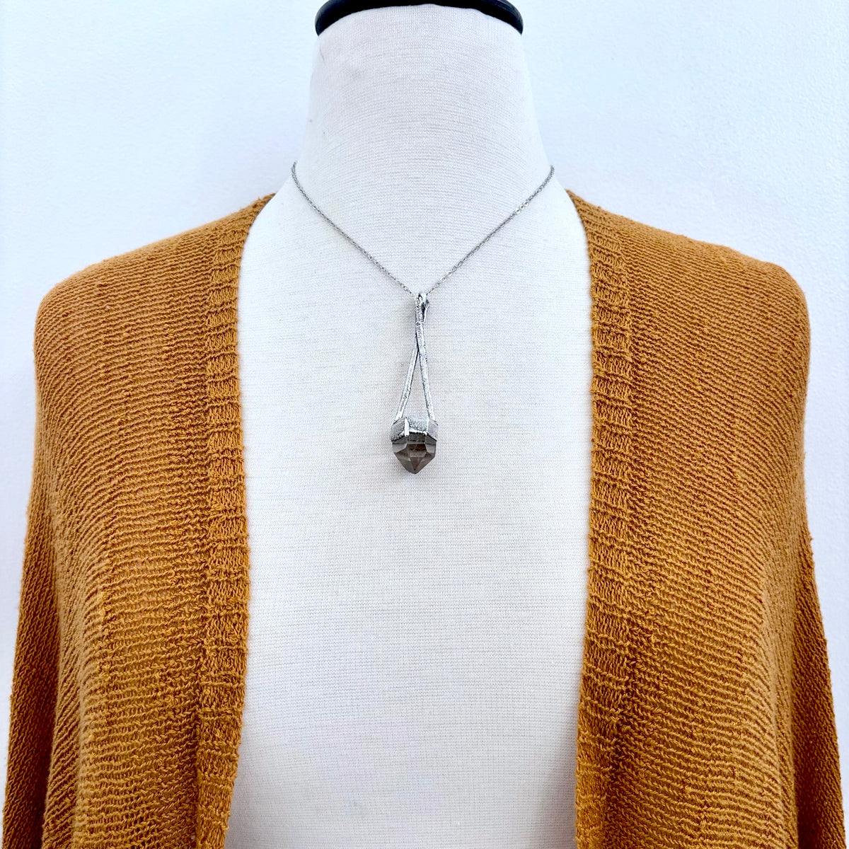 Silver quartz crystal necklace from FOXLARK's Sticks & Stones Collection featuring a polished pendant on a delicate chain.