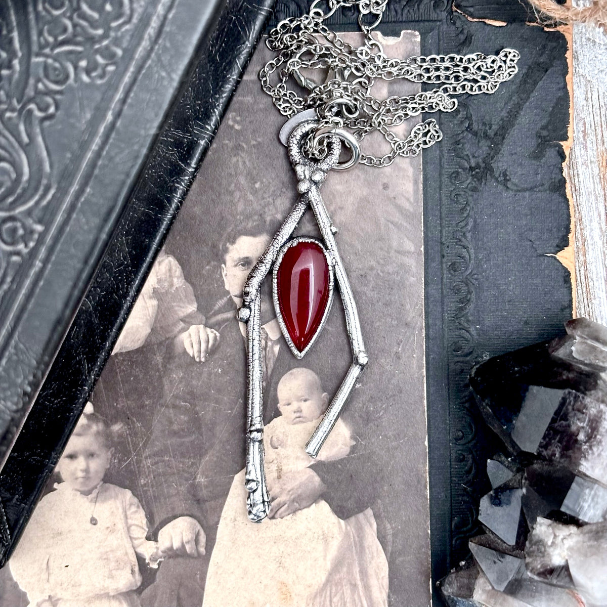 Silver carnelian crystal necklace from FOXLARK's Sticks & Stones collection, featuring a polished orange gemstone pendant.