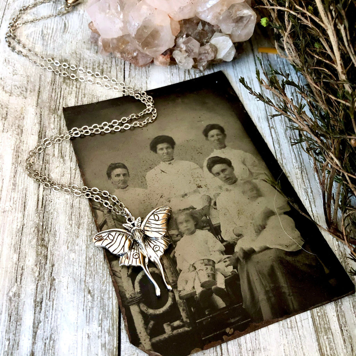 Sterling silver Luna moth necklace pendant from FOXLARK Tiny Talisman Collection, 23x24mm, featuring detailed moth design.
