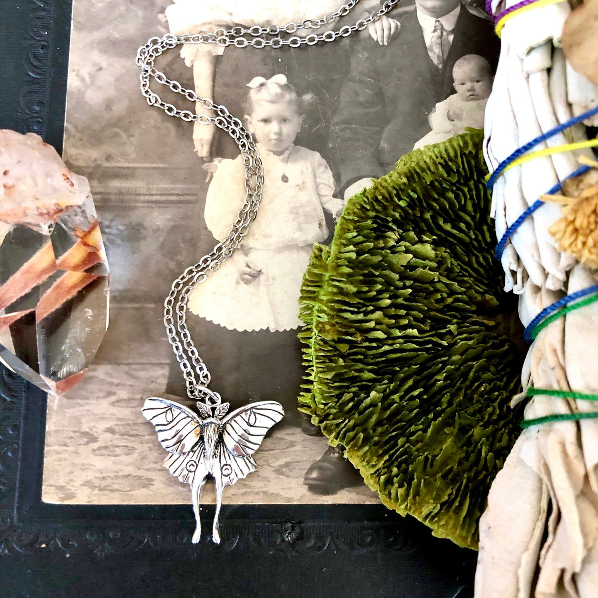 Sterling silver Luna moth pendant from FOXLARK's Tiny Talisman Collection, measuring 23x24mm, featuring intricate moth design.