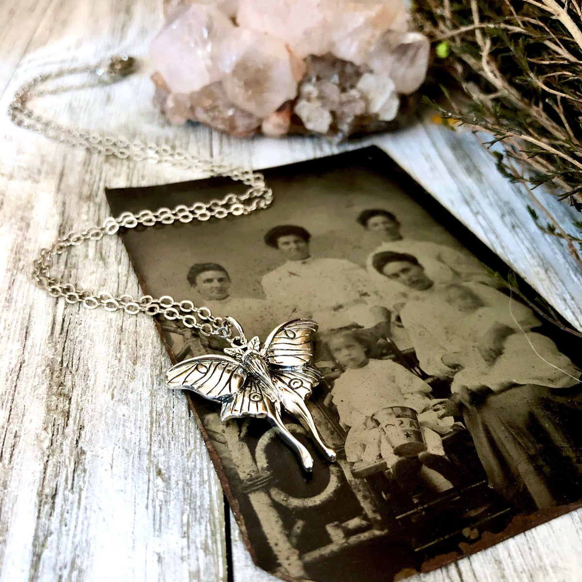 Sterling silver Luna moth necklace pendant from FOXLARK Tiny Talisman Collection, 23x24mm, featuring detailed moth design.