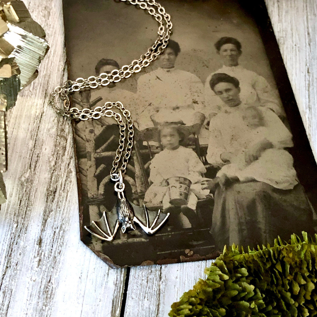 Sterling silver Tiny Bat Necklace Pendant from FOXLARK's Tiny Talisman Collection, measuring 12x20mm, featuring a detailed bat design.