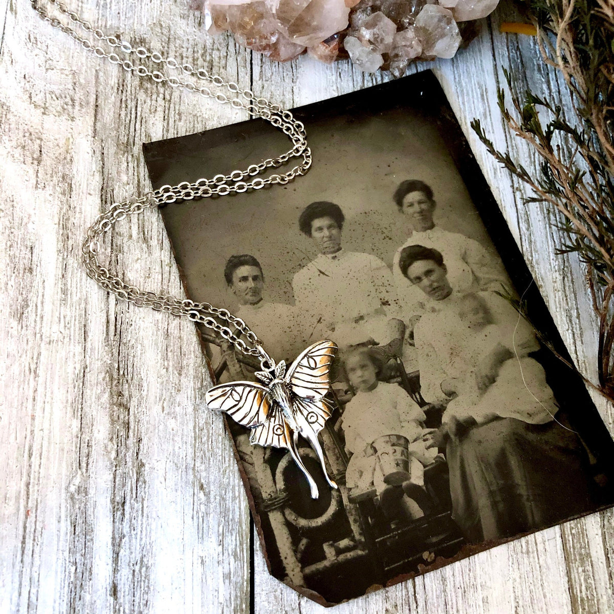 Sterling silver Luna moth pendant from FOXLARK's Tiny Talisman Collection, 23x24mm, featuring detailed moth design.
