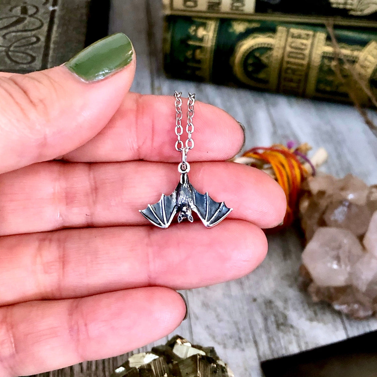 Sterling silver tiny bat pendant necklace from FOXLARK Tiny Talisman Collection, 12x20mm, featuring a detailed bat charm.