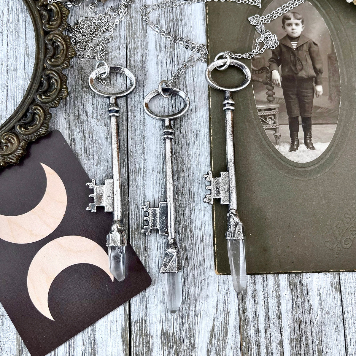 Vintage clear quartz crystal skeleton key necklace pendant in fine silver from Foxlark Collection, showcasing intricate design and craftsmanship.