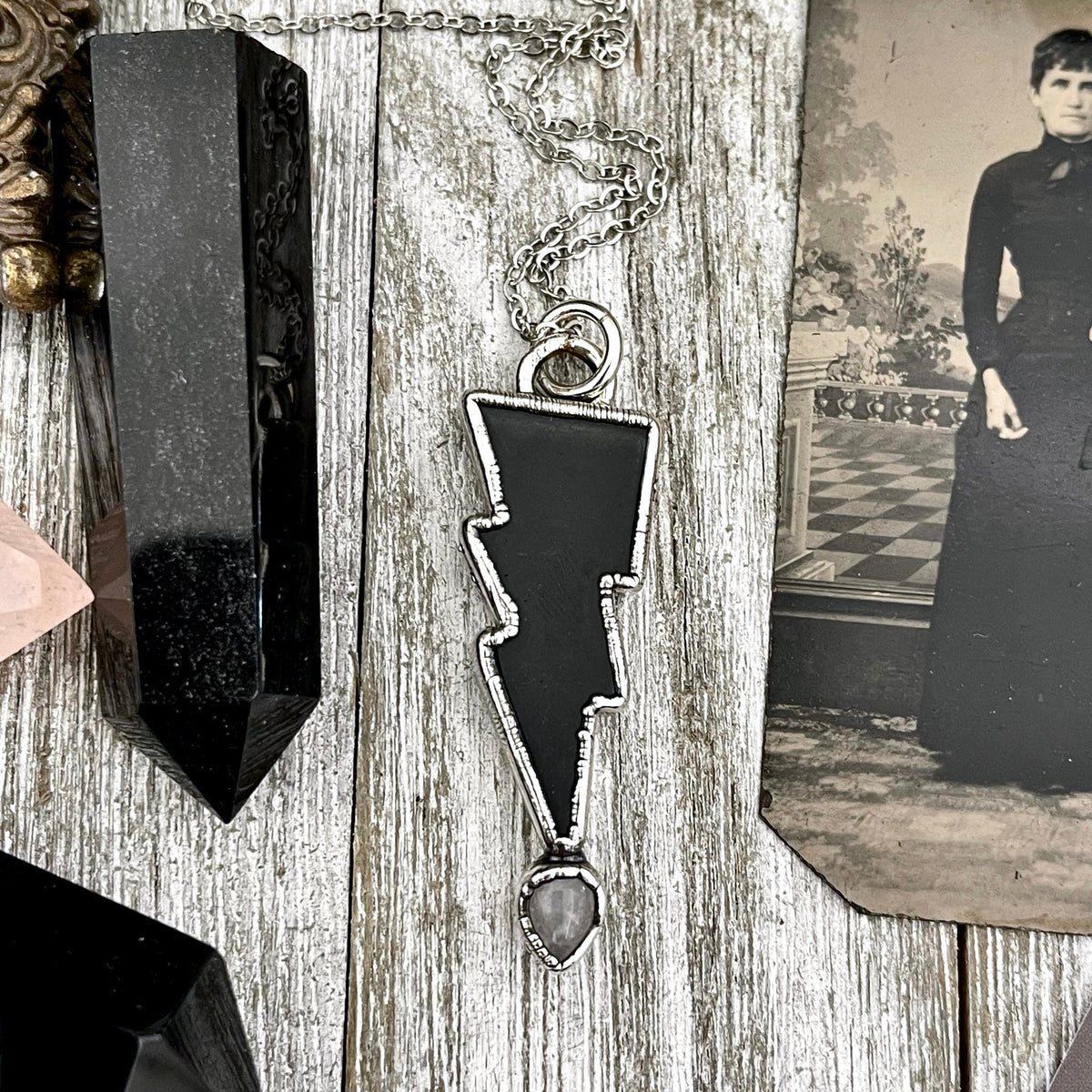 Black onyx and clear quartz crystal lightning bolt pendant necklace by FOXLARK, Gothic jewelry featuring striking gemstone details.