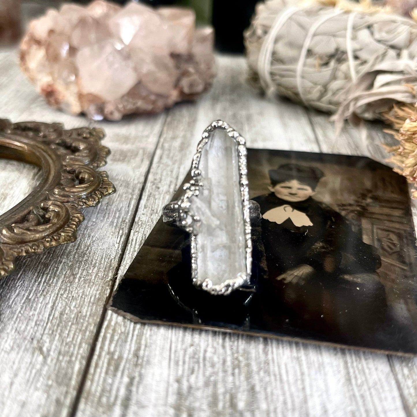 Raw clear quartz crystal point ring set by FOXLARK, featuring fine silver bands in sizes 5-9, one-of-a-kind jewelry from the Foxlark Collection.