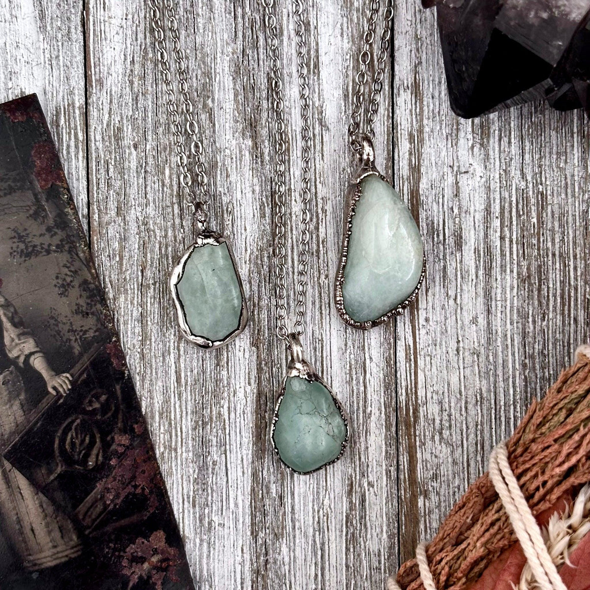 Delicate Foxlark necklace featuring a pebble-shaped pendant in aquamarine, clear quartz, or black onyx with a silver chain.