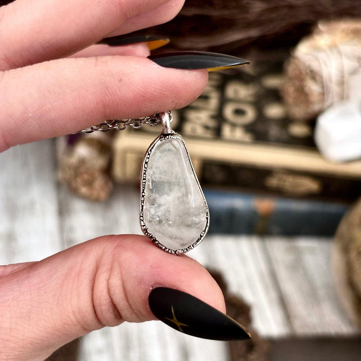 Silver Foxlark necklace featuring a dainty pebble pendant in aquamarine, clear quartz, or black onyx, elegant jewelry accessory.