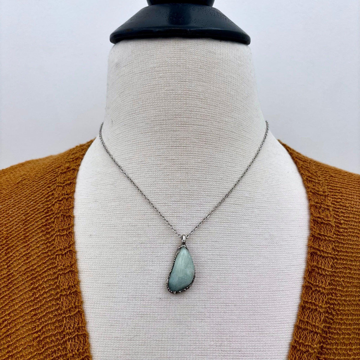 Dainty Foxlark necklace featuring a pebble-shaped aquamarine, clear quartz, or black onyx pendant in silver setting.