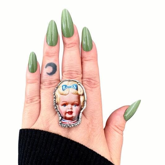 Blue Bow Betty Doll statement ring by FOXLARK, Fine Silver size 9, featuring a detailed doll design in vibrant blue.