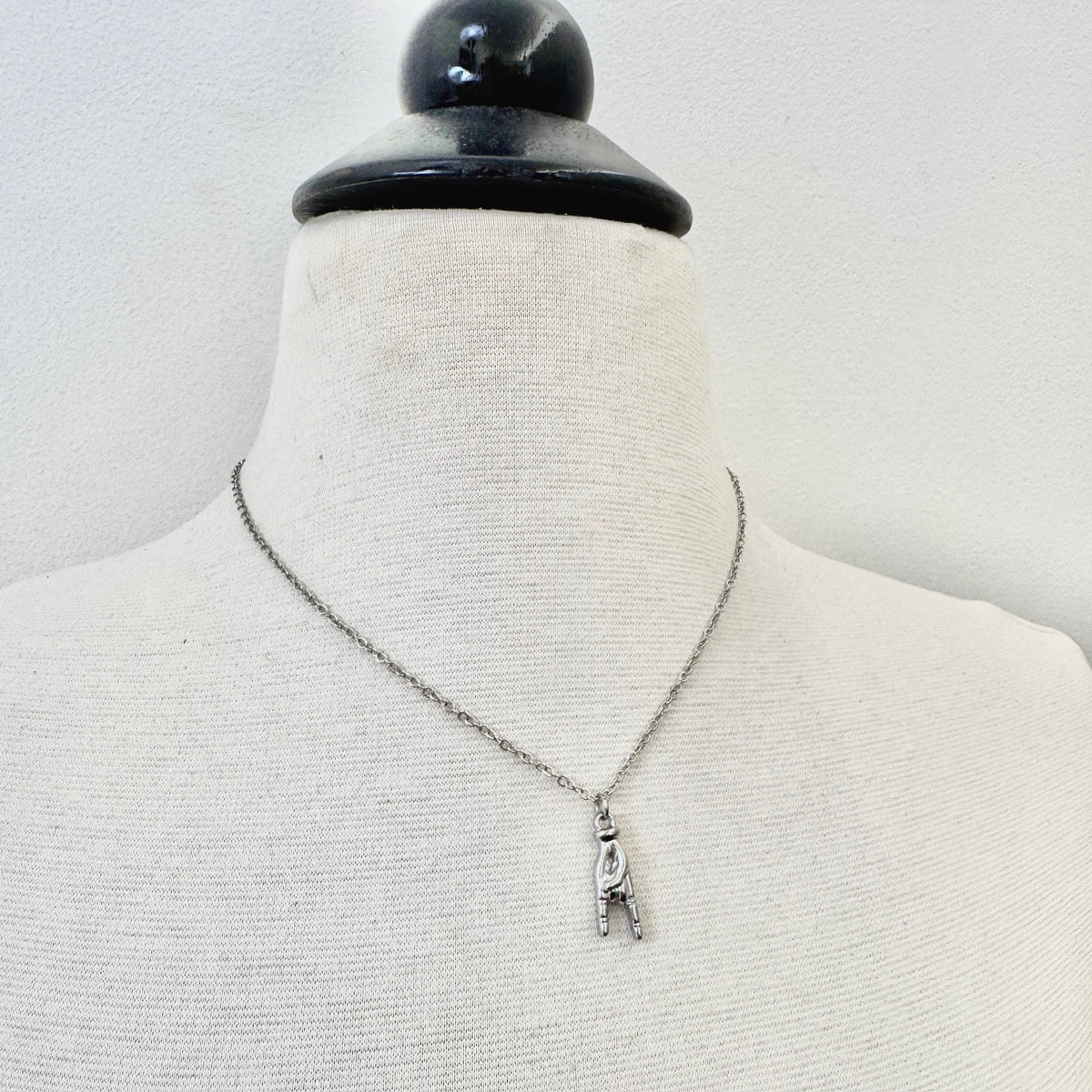 Rock On Hand Charm stainless steel pendant necklace from the Lucky Charm Bar at Foxlark