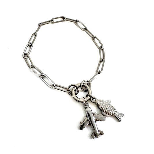 FOXLARK Load-It-Up Charm Collector Bracelet featuring paperclip carabiner chain and assorted charms on a jewelry display