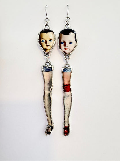 Silver mismatched doll head and leg earrings with long dangle design from FOXLARK's Weirdlings Collection.