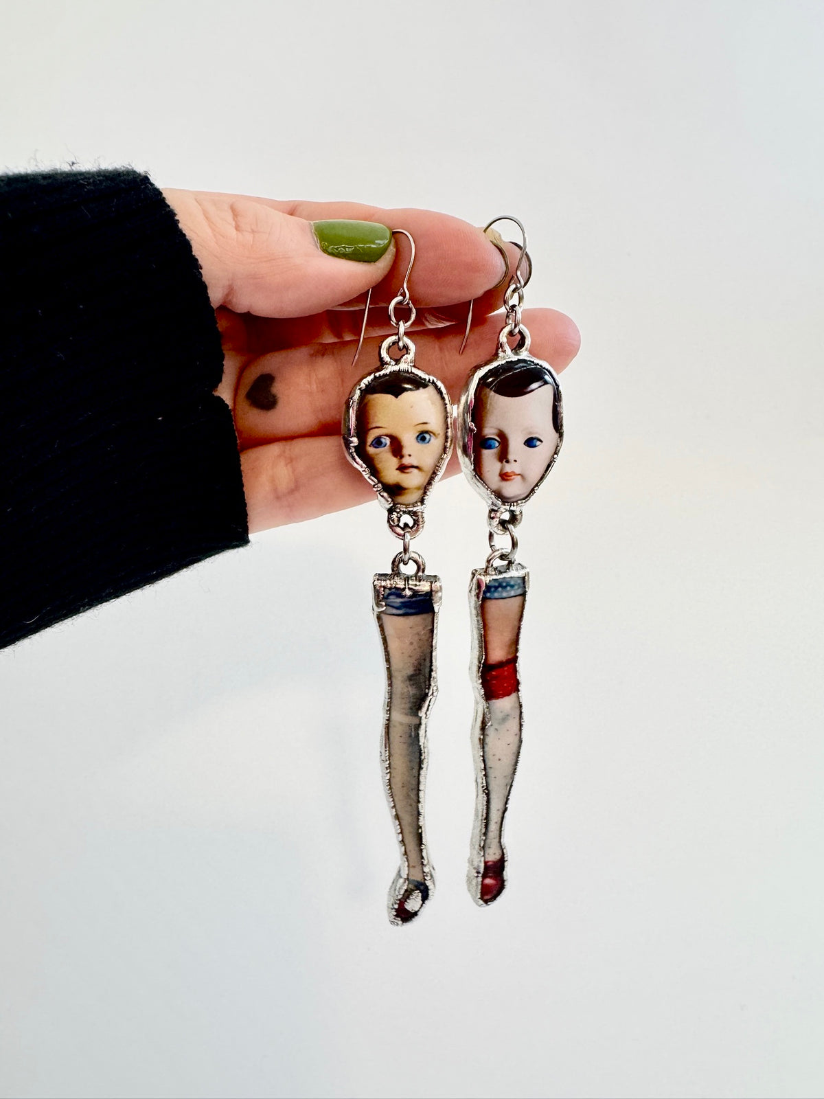 Foxtark Mismatched Doll Head and Leg earrings, long silver dangle statement earrings from The Weirdlings Collection.