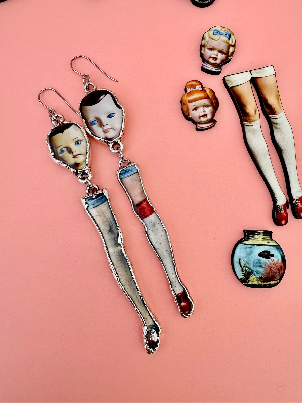 Foxtark Mismatched Doll Head and Leg earrings, long silver dangle statement earrings from The Weirdlings Collection.