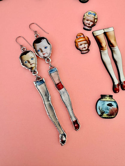 Foxtark Mismatched Doll Head and Leg earrings, long silver dangle statement earrings from The Weirdlings Collection.