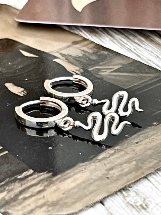 Sterling silver huggie hoop earrings with mini snake design, 27x11mm, by FOXLARK, featuring detailed snake motifs and smooth hoop shape.